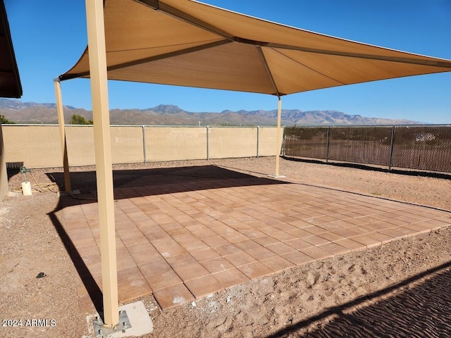 view of patio with a mountain view and a fenced backyard