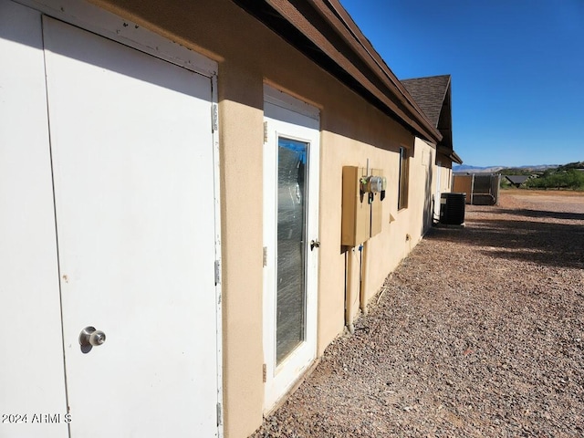 view of property exterior featuring cooling unit and stucco siding