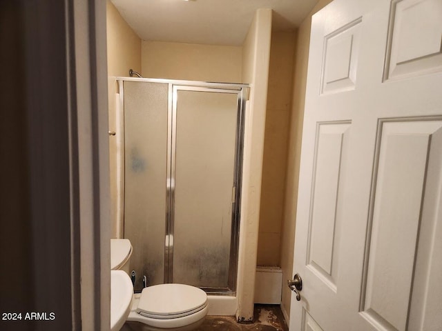 full bathroom with toilet and a stall shower