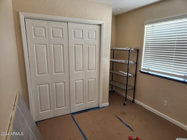 bedroom with a closet and baseboards