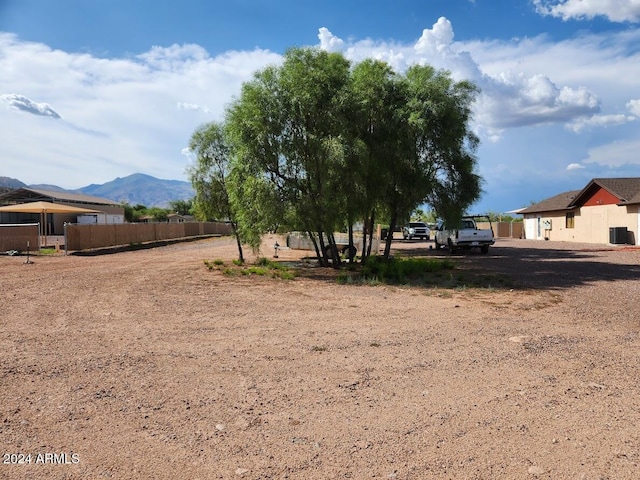 view of yard with a mountain view and fence
