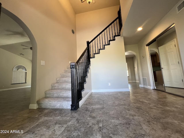 15230 N Blackbird Dr, Fountain Hills, AZ 85268 - staircase featuring arched walkways, ceiling fan, baseboards, and a high ceiling
