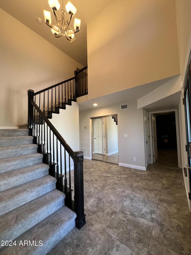 15230 N Blackbird Dr, Fountain Hills, AZ 85268 - stairway featuring a chandelier, high vaulted ceiling, and baseboards