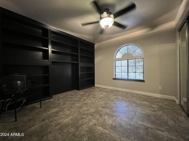 15230 N Blackbird Dr, Fountain Hills, AZ 85268 - unfurnished living room with built in shelves, baseboards, and a ceiling fan