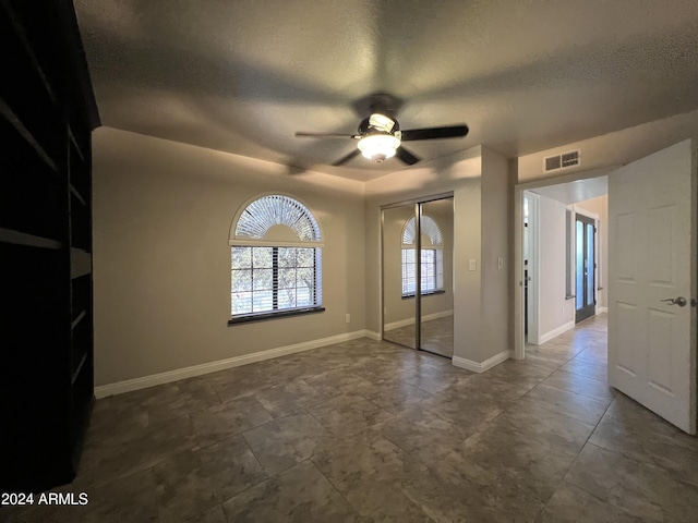 15230 N Blackbird Dr, Fountain Hills, AZ 85268 - unfurnished bedroom with a textured ceiling, a closet, ceiling fan, and baseboards