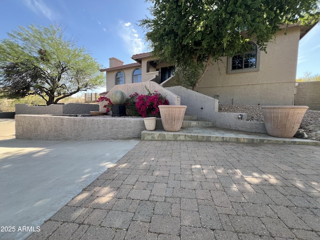 15230 N Blackbird Dr, Fountain Hills, AZ 85268 - view of front facade with stucco siding, a patio, and a chimney
