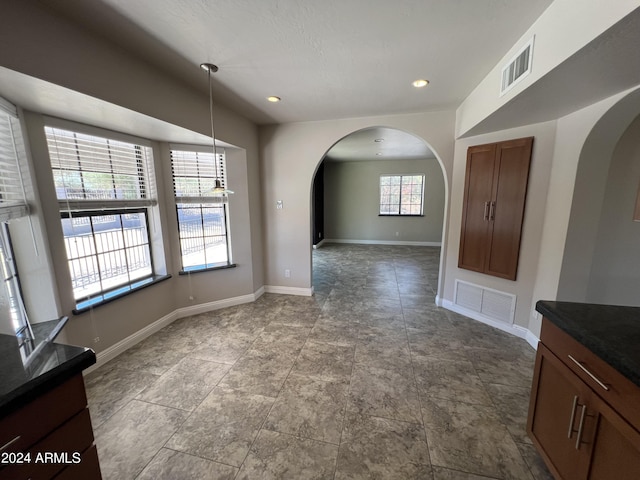 15230 N Blackbird Dr, Fountain Hills, AZ 85268 - unfurnished dining area featuring arched walkways, baseboards, and recessed lighting