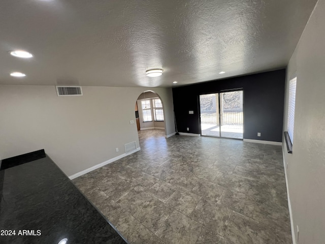 15230 N Blackbird Dr, Fountain Hills, AZ 85268 - spare room with arched walkways, baseboards, a textured ceiling, and recessed lighting