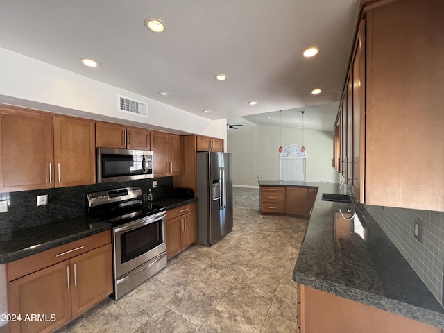 15230 N Blackbird Dr, Fountain Hills, AZ 85268 - kitchen with appliances with stainless steel finishes, brown cabinetry, tasteful backsplash, recessed lighting, and decorative light fixtures