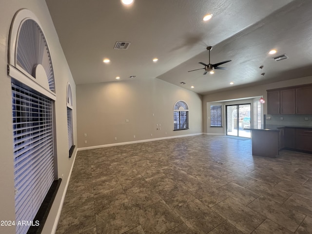 15230 N Blackbird Dr, Fountain Hills, AZ 85268 - unfurnished living room with ceiling fan, lofted ceiling, baseboards, recessed lighting, and dark stone finish floors
