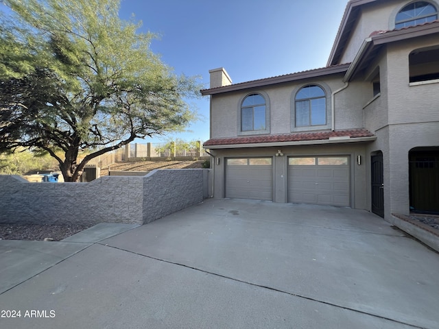 15230 N Blackbird Dr, Fountain Hills, AZ 85268 - view of front of home with a chimney, driveway, a garage, and stucco siding