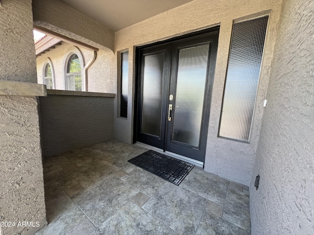 15230 N Blackbird Dr, Fountain Hills, AZ 85268 - view of exterior entry with stucco siding, french doors, and a balcony