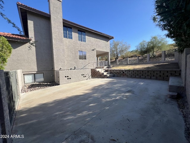 15230 N Blackbird Dr, Fountain Hills, AZ 85268 - view of property exterior featuring stucco siding, a chimney, a patio, and a tiled roof