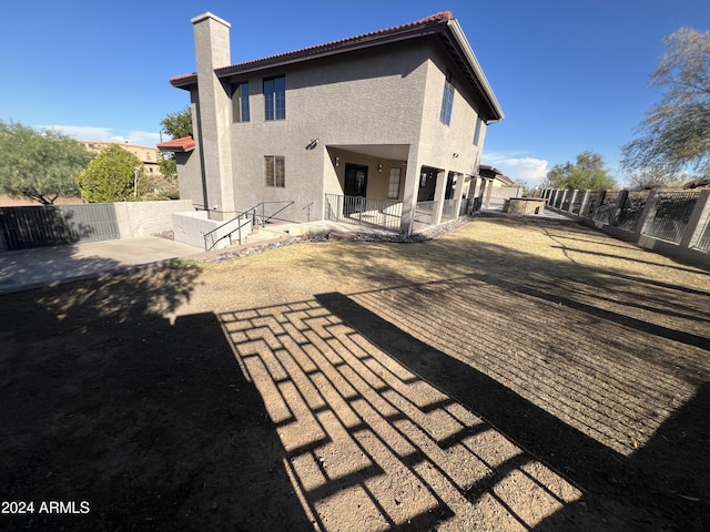 15230 N Blackbird Dr, Fountain Hills, AZ 85268 - rear view of house featuring stucco siding, a patio, a chimney, and a fenced backyard