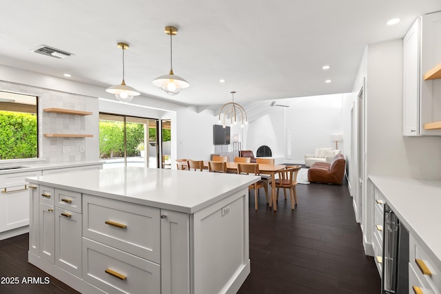 8007 E Del Tesoro Dr, Scottsdale, AZ 85258 - kitchen with dark wood-style floors, light countertops, recessed lighting, a kitchen island, and pendant lighting
