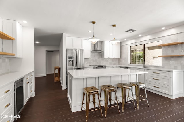 8007 E Del Tesoro Dr, Scottsdale, AZ 85258 - kitchen featuring open shelves, wall chimney exhaust hood, decorative backsplash, a breakfast bar, and stainless steel appliances