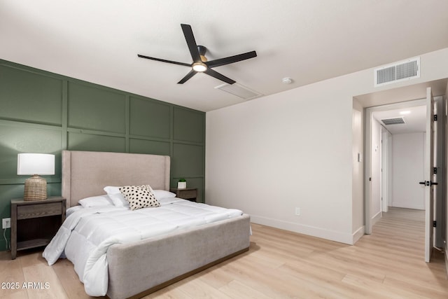 2348 E Diamond Ave, Mesa, AZ 85204 - bedroom featuring a decorative wall, light wood-style floors, ceiling fan, and baseboards