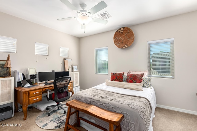 bedroom featuring multiple windows, carpet, and ceiling fan