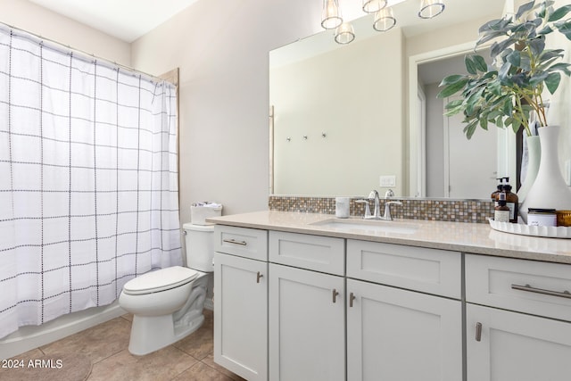 full bathroom with toilet, tile patterned flooring, shower / bath combination with curtain, vanity, and tasteful backsplash