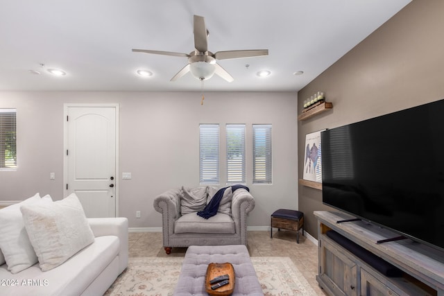 tiled living room with ceiling fan and plenty of natural light