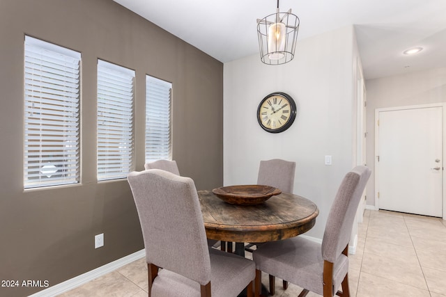 dining room with light tile patterned floors and a chandelier