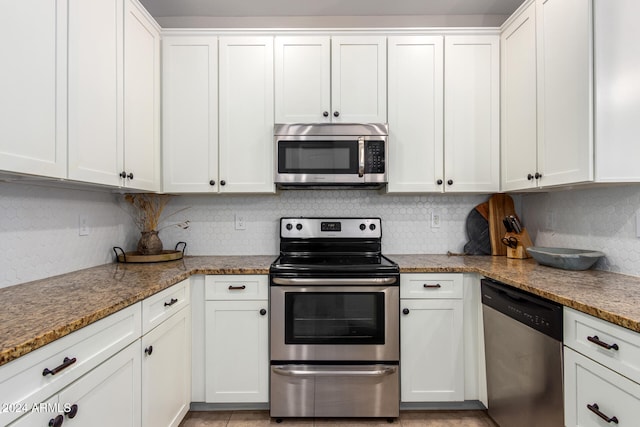 kitchen featuring white cabinetry, stainless steel appliances, and stone countertops