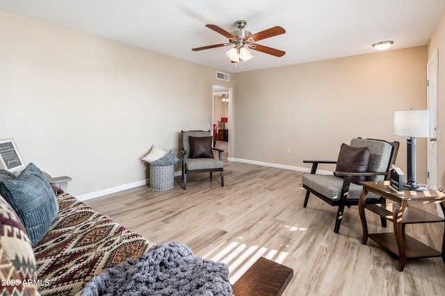 living area with light hardwood / wood-style floors and ceiling fan