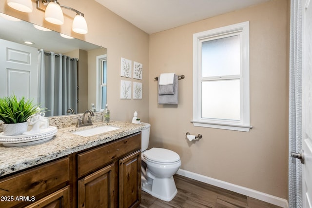 bathroom with vanity, wood-type flooring, and toilet