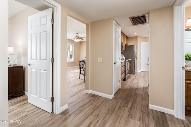 corridor featuring light wood-type flooring