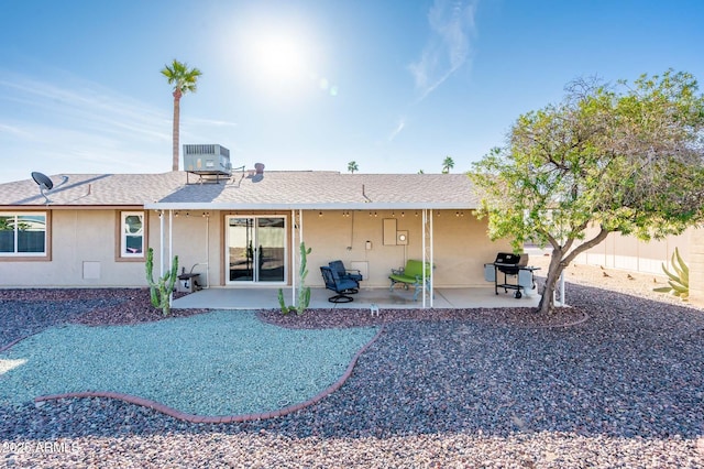 rear view of property with central AC and a patio area