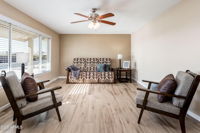 sitting room with light hardwood / wood-style flooring and ceiling fan