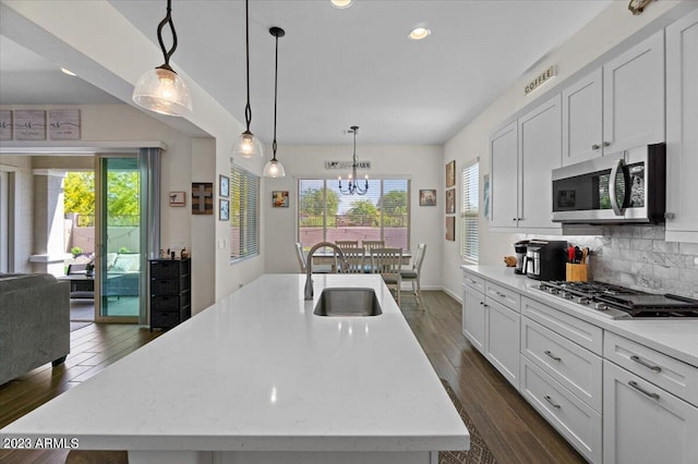 kitchen with white cabinetry, a notable chandelier, appliances with stainless steel finishes, sink, and pendant lighting