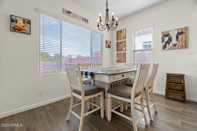 dining space with dark wood-type flooring and a notable chandelier