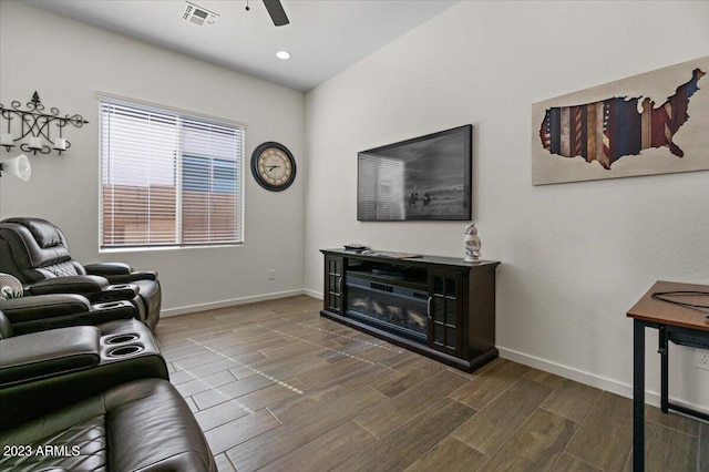 living room with dark hardwood / wood-style floors and ceiling fan