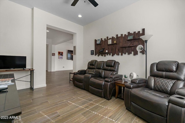 living room featuring ceiling fan and wood-type flooring