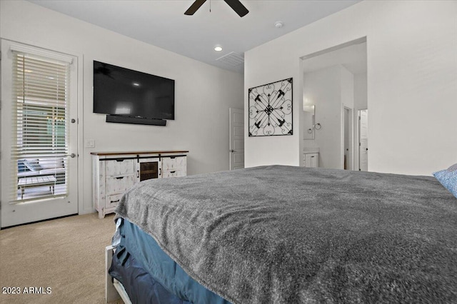 carpeted bedroom with ensuite bath, ceiling fan, and access to outside