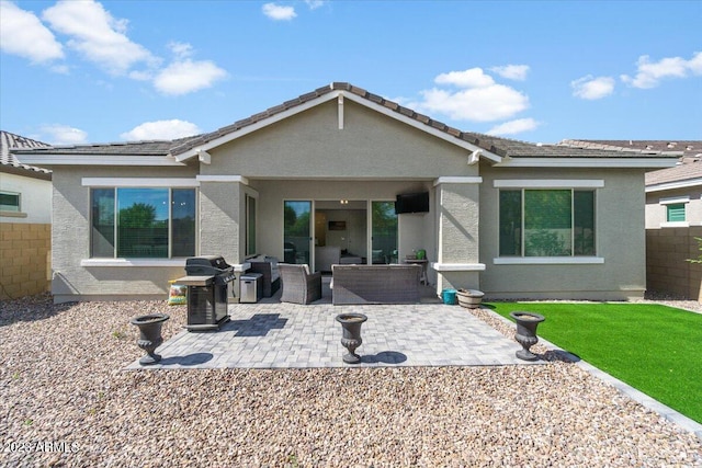 back of property with a patio and outdoor lounge area