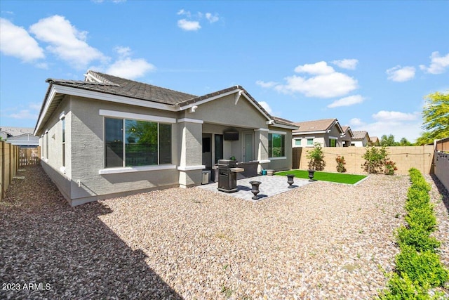 back of property featuring a patio