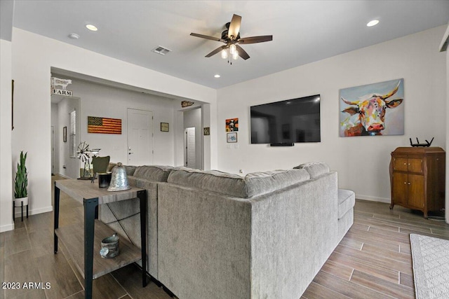 living room featuring light hardwood / wood-style floors and ceiling fan