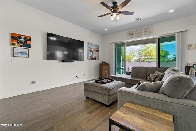 living room with ceiling fan and dark hardwood / wood-style floors