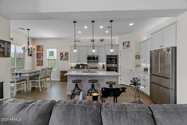 living room featuring dark hardwood / wood-style flooring, sink, and a chandelier