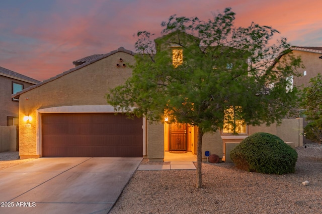2324 W Melody Dr, Phoenix, AZ 85041 - view of front of house with driveway, a garage, and stucco siding