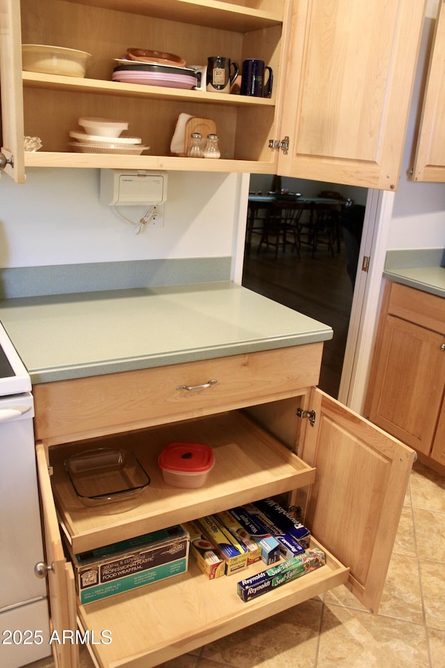 interior space featuring light brown cabinetry, light countertops, and open shelves