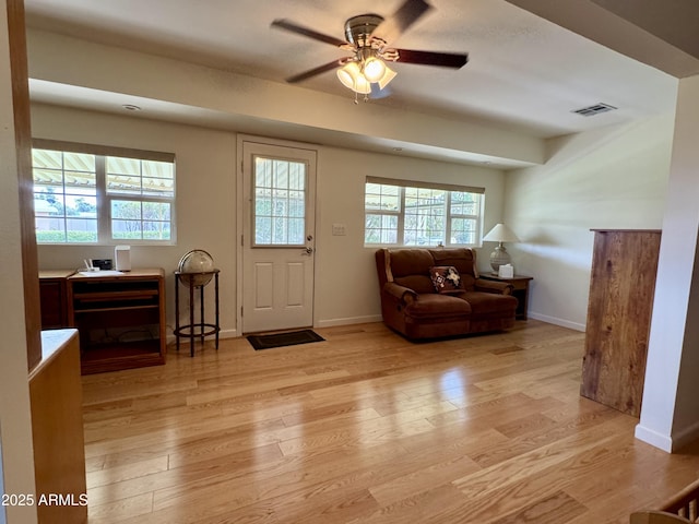 foyer featuring visible vents, ceiling fan, light wood-style flooring, and baseboards