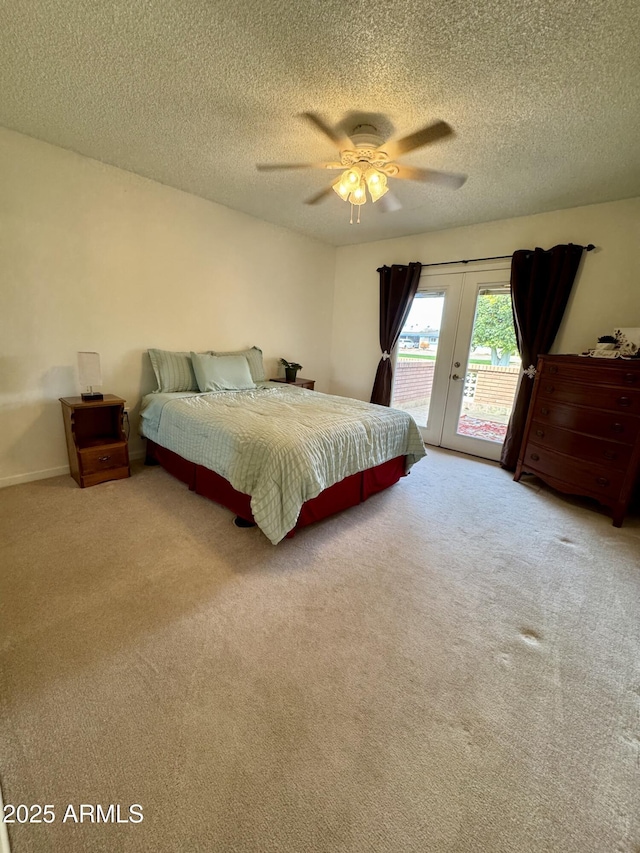 bedroom with access to exterior, carpet floors, french doors, a ceiling fan, and a textured ceiling