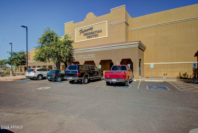 view of building exterior featuring uncovered parking