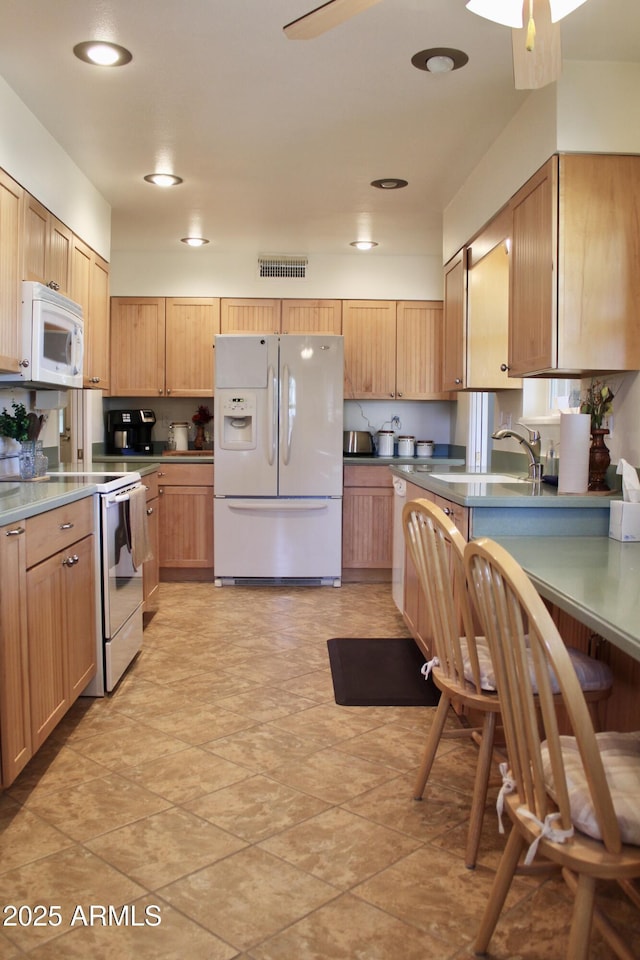 kitchen featuring white appliances, recessed lighting, visible vents, and a ceiling fan