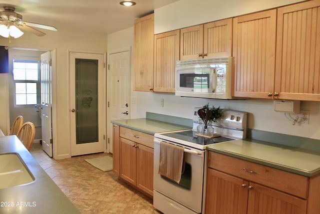 kitchen with light tile patterned floors, light countertops, ceiling fan, a sink, and white appliances