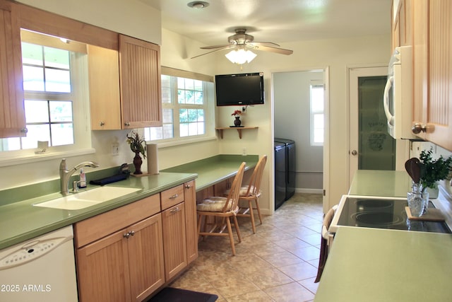 kitchen with light tile patterned floors, ceiling fan, white appliances, a sink, and baseboards