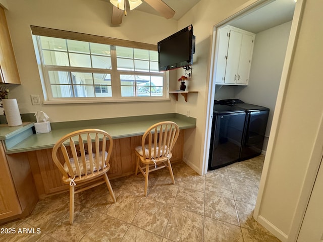 kitchen with ceiling fan, separate washer and dryer, baseboards, white cabinets, and built in desk